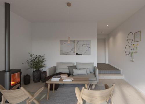 uma sala de estar com um sofá, uma mesa e uma lareira em Västös Strand by FIRST Hotels em Lärbro