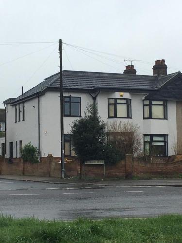 a white house with a fence in front of it at Ar-Rahman, 1 bed room and 1 Living room apartment in Kent
