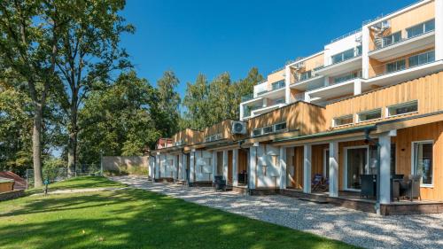 an exterior view of a building with a yard at Stranda in Giżycko