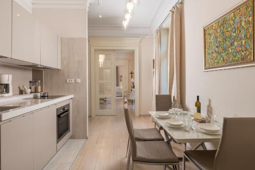 a kitchen and dining room with a table and chairs at Villa Sokol Apartments Opatija center in Opatija