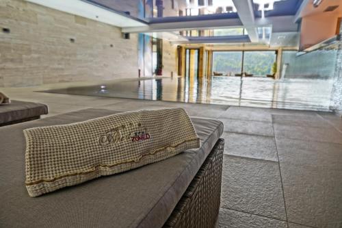 a pillow sitting on a bench in a building at Apart & Spa Zoned in Kopaonik