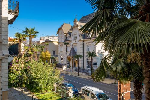 a street with cars parked on the side of the road at Villa Sokol Apartments Opatija center in Opatija