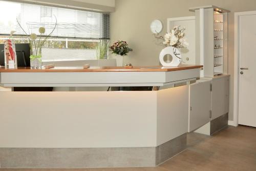a kitchen with a white counter and a window at Waldhotel Bad Soden in Bad Soden am Taunus