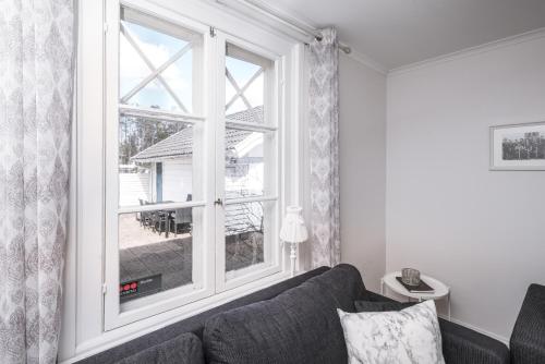 a living room with a couch and a large window at Isaberg Golfklubb in Hestra