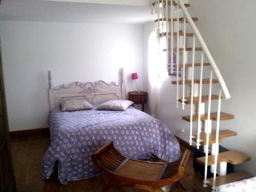 a bedroom with a bed and a spiral staircase at Villa Novella in Le Beausset