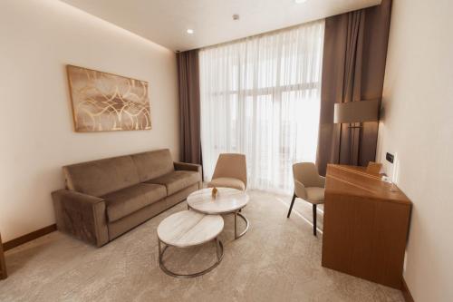 a living room with a couch and a table at Farovon Khiva Hotel in Khiva