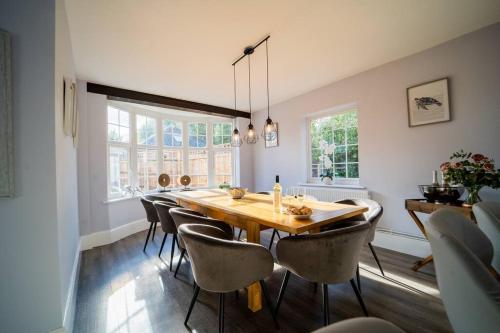 a dining room with a wooden table and chairs at The Cedars, Cromer, a 7.5 minute walk to the beach in Cromer