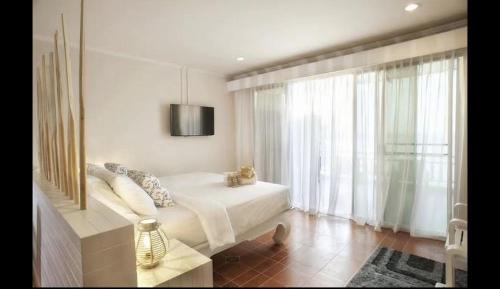 a bedroom with a bed and a large window at AT SEA Patong in Patong Beach