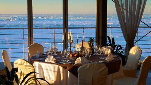 a dining table with a view of the ocean at Boutique Hotel Light House Jurmala in Jūrmala