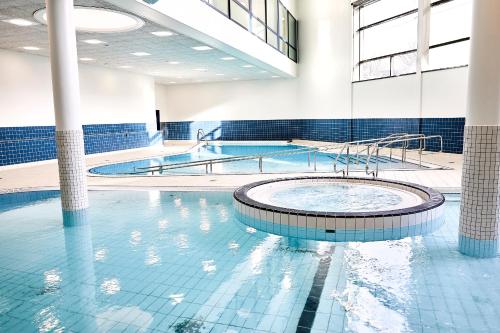 a pool in a building with two swimming pools at CPH Hotel in Copenhagen