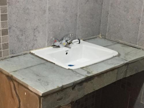 a bathroom counter with a sink and a mirror at Bubbles Lodge Kinangop in South Kinangop