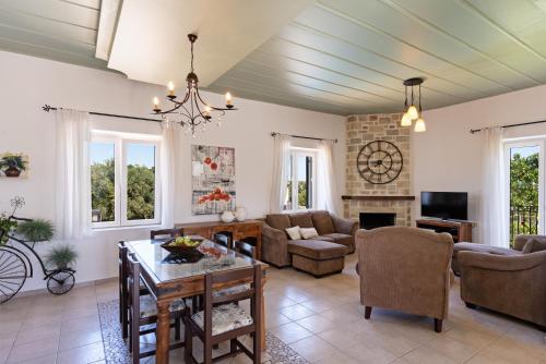 a living room filled with furniture and a fireplace at The Artemis Home, pure rustic romance, By ThinkVilla in Astérion