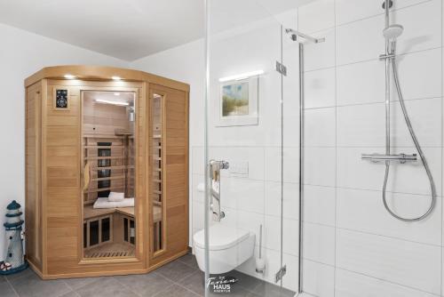 a bathroom with a shower with a toilet and a glass door at Hafenoase in Olpenitz