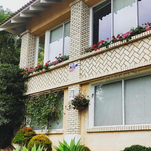a house with flower boxes on the side of it at Bela Vista Hospedagem in Joinville