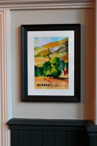 a framed picture of a painting on a wall at The Crabtree Inn in Shoreham-by-Sea