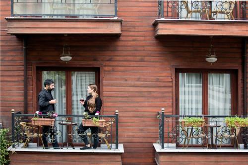a man and a woman standing on a balcony at Garden House Hotel - Special Class in Istanbul