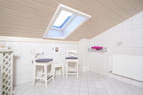 a bathroom with a skylight and two stools at Auszeit-Oetztal in Sautens
