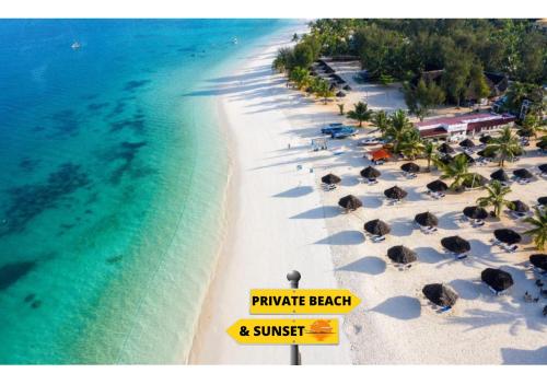 an aerial view of a beach with umbrellas and the ocean at Kibanda Natural Kendwa Villa in Kendwa