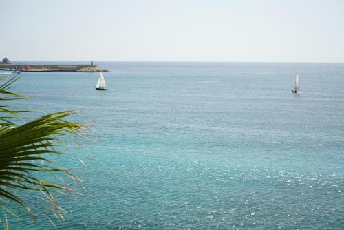 three sailboats in the water with at Nomad Hotel - Xábia Port in Jávea
