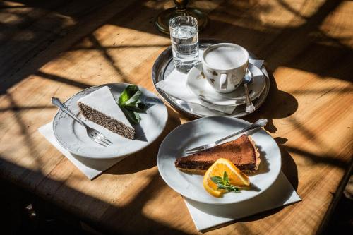 a table with two plates of cake and a cup of coffee at Burg Bernstein in Bernstein