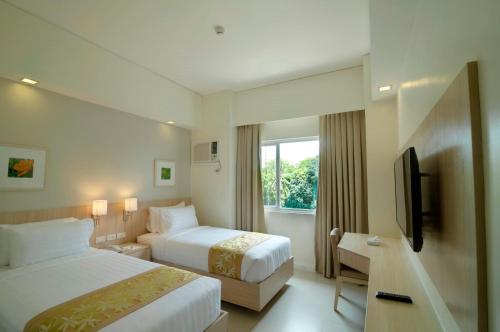 Postel nebo postele na pokoji v ubytování Zerenity Hotel & Suites