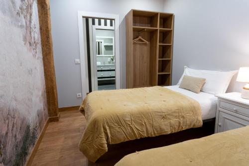 a bedroom with two beds and a closet at SF Avenue Santander in Santander
