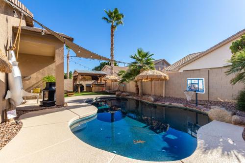 ein Pool vor einem Haus in der Unterkunft Tiki Time Perfect Pool Home in Chandler! Sleeps 8! home in Chandler