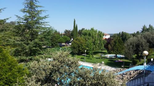 a view of a park with a swimming pool at Apartamentos Baños de Ledesma in Salamanca