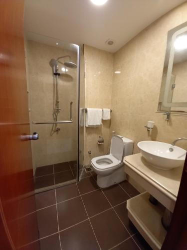 a bathroom with a shower and a toilet and a sink at RED SEA HOTEL APARTMENT in Djibouti