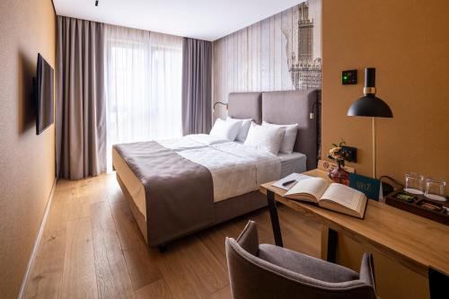 a hotel room with a bed and a desk at Loft7 in Lviv