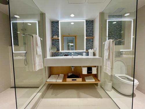 
a bathroom with a tub, toilet and sink at The Morgan Resort Spa & Village in Simpson Bay

