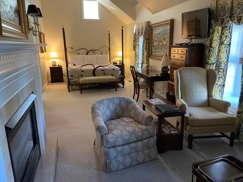 a living room with a couch and a chair at The Inn at Montchanin Village & Spa in Montchanin