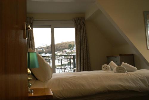 a hotel room with a bed and a window at Riverside 3 in Dartmouth