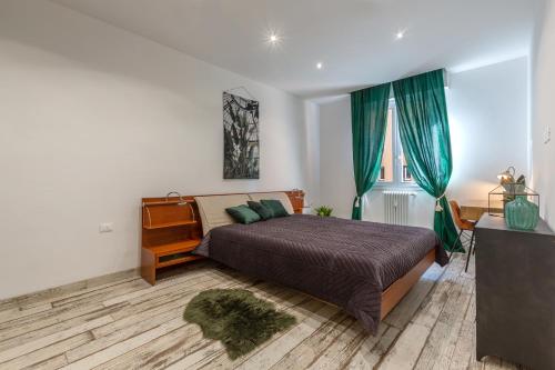a bedroom with a bed and a dresser and a window at San Donato Fiera Bologna Green House x6 in Bologna