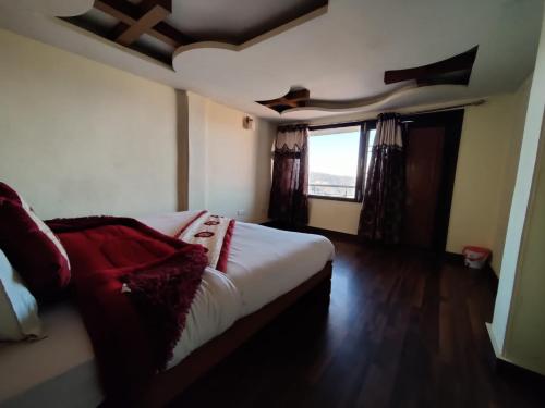 a bedroom with a bed and a window at Wintry homes 5 Bhk Villa in Shimla