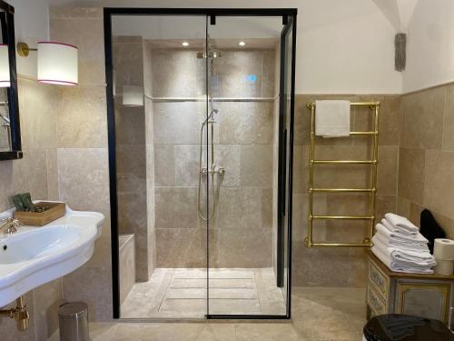 a bathroom with a shower and a sink at Castello Di Meleto in Gaiole in Chianti
