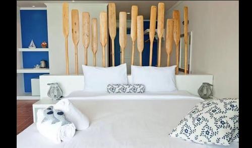 a bedroom with a white bed with shoes on it at AT SEA Patong in Patong Beach