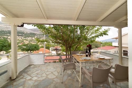 a table and chairs on a patio with a view at Minas Apartments in Divarata