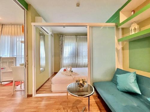 a living room with a couch and a mirror at The trust huahin resort condo greeny room in Hua Hin