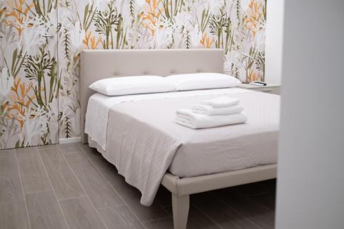 a bedroom with a bed with towels on it at Bed and Breakfast: Nonna Rosa in Bitonto
