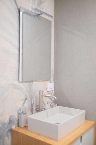 a bathroom with a white sink and a mirror at Bed and Breakfast: Nonna Rosa in Bitonto
