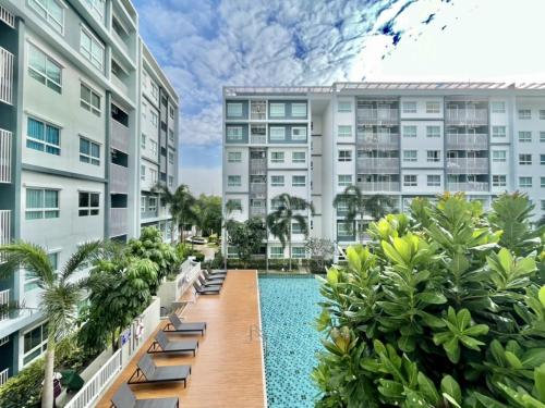 an apartment complex with a swimming pool and buildings at The trust huahin sky room condo pool view in Hua Hin