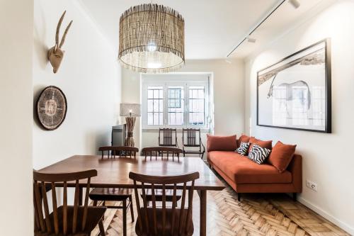 a living room with a couch and a table at Casas da Tapada in Lisbon
