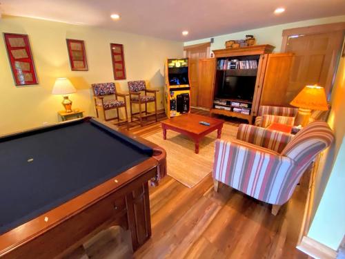 a living room with a pool table in it at E5 Beautiful Bretton Woods slopeside home amazing views of Mount Washington Hot Tub AC in Carroll