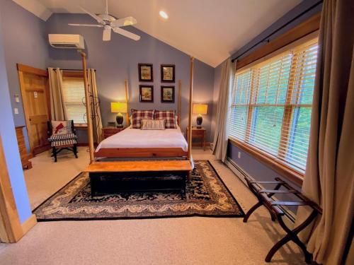 a bedroom with a bed and a large window at E5 Beautiful Bretton Woods slopeside home amazing views of Mount Washington Hot Tub AC in Carroll