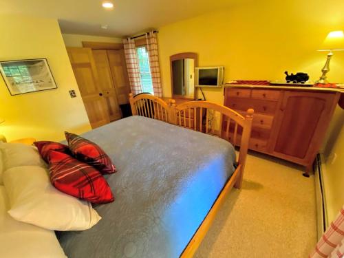 a bedroom with a bed with pillows on it at E5 Beautiful Bretton Woods slopeside home amazing views of Mount Washington Hot Tub AC in Carroll
