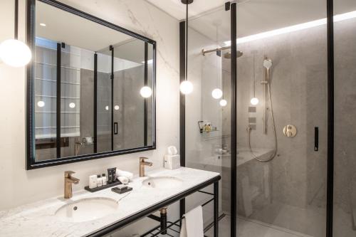 a bathroom with two sinks and a shower at Luxury Apartments Palazzo Nani in Venice