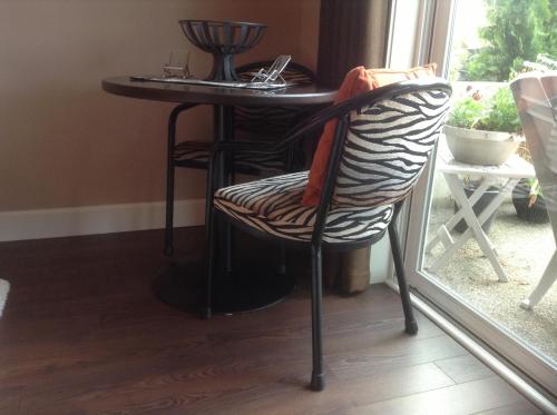 a table and chairs in a room next to a window at Rockwood House in Nanaimo