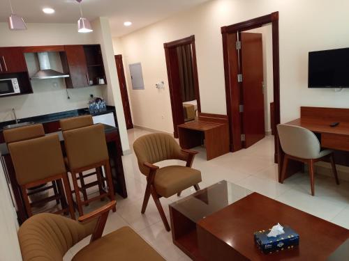 a living room with a kitchen and a dining room at RED SEA HOTEL APARTMENT in Djibouti
