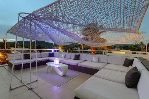 a rooftop patio with a couch and a table at Serena Villa in Ibiza Town